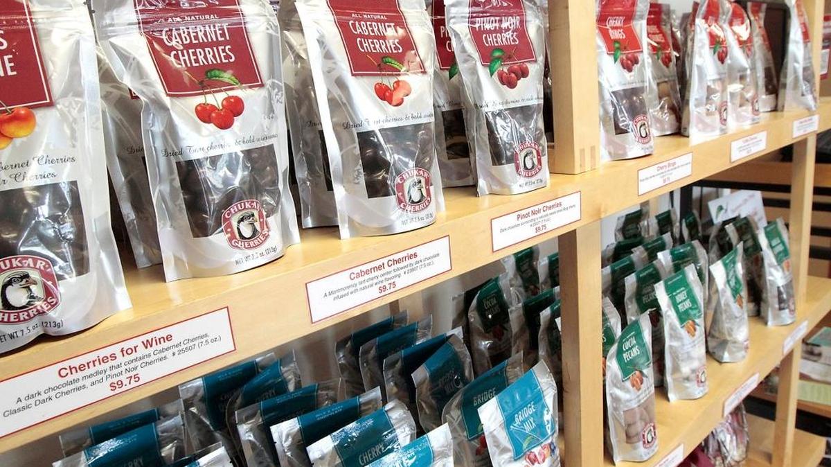 An assortment of bags filled with Chukar Cherries line the display shelves at the Prosser store.