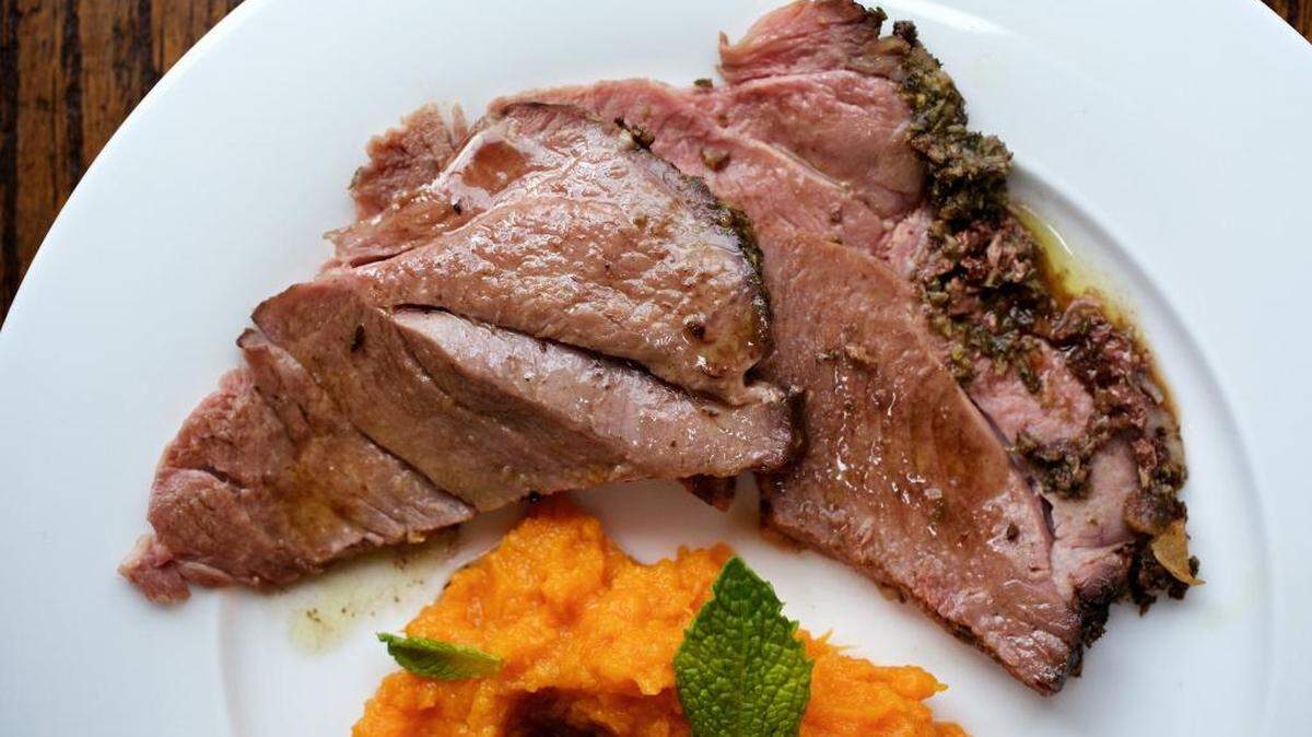 Tender, rosy slices from a boneless lamb roast rubbed with a paste of garlic and mint is a great option for modest holiday gatherings.