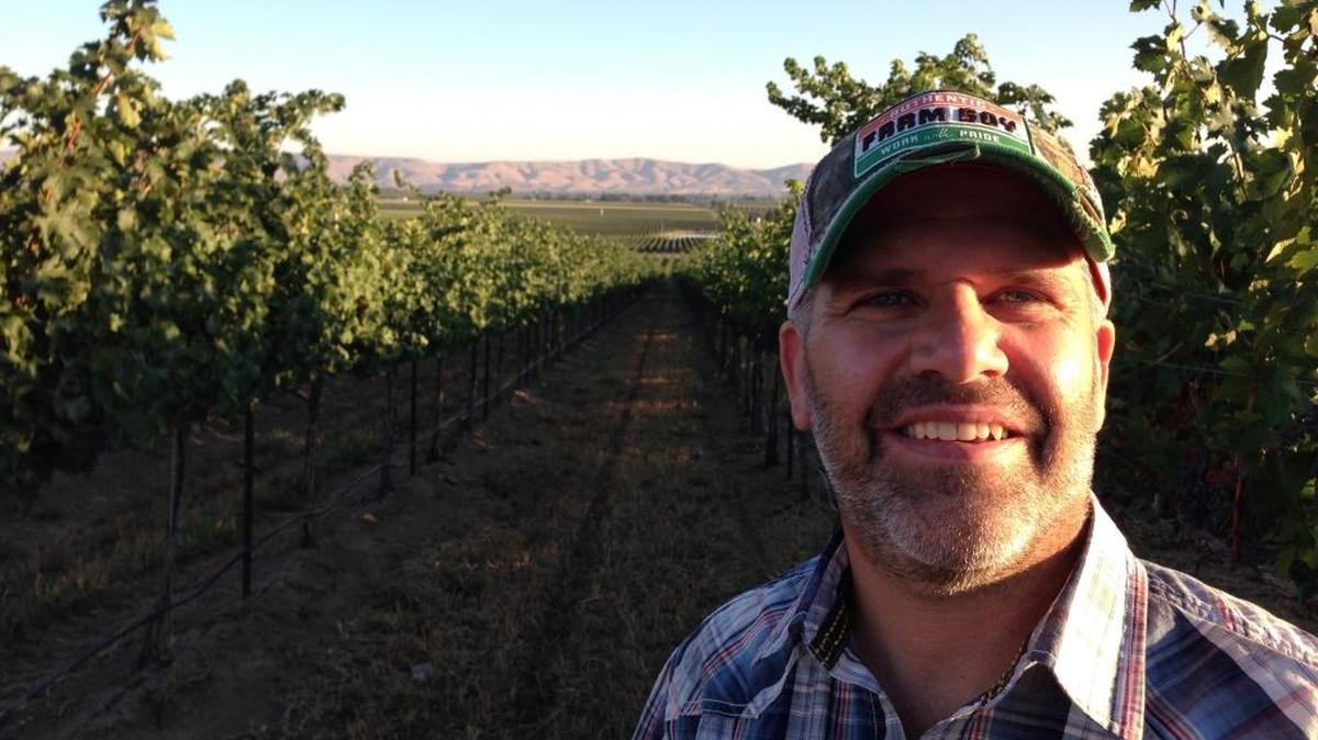 Robert Smasne stands in Otis Vineyard north of the Yakima Valley town of Grandview. Smasne grew up nearby and nw is one of Washington’s top winemakers. He recently opened a tasting room at the Vintners Village in Prosser.