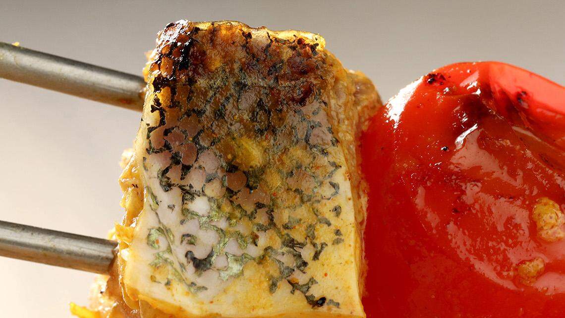 Mahi mahi kebabs are marinated in a spicy mixture, made with yogurt, onion, garlic, paprika and other spices, before being grilled along with fresh tomatoes. (Michael Tercha/Chicago Tribune/TNS) 