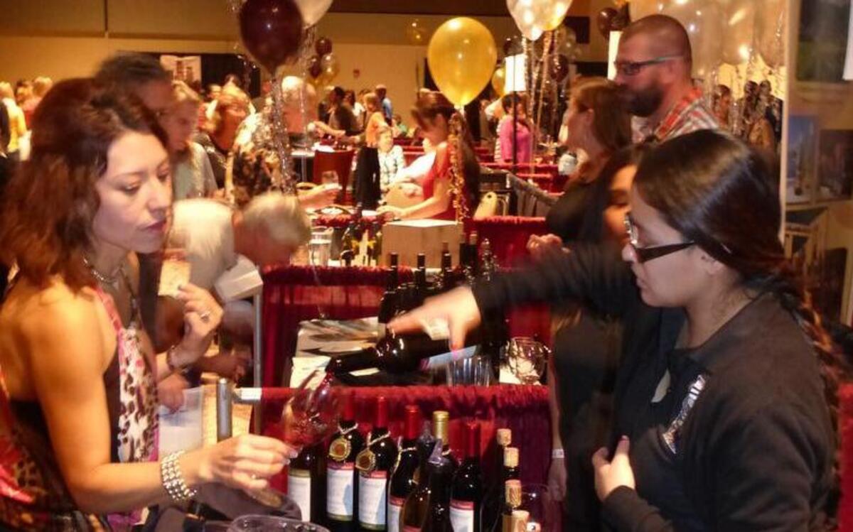 Vereyida Ponce, a student in the Yakima Valley Community College wine making program serves samples of the student-made wines to attendees at Saturday's Tri-City Wine Festival.