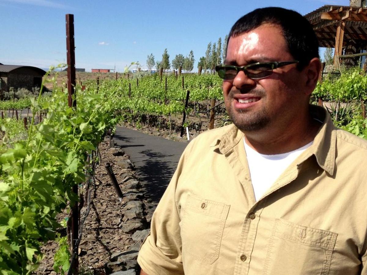 Freddy Arredondo, a classically trained chef who learned winemaking at Walla Walla Community College, stands between rows of his family’s vineyards at Cave B Estate Winery in George, Wash.