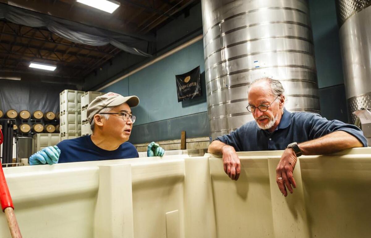 Robert Takahashi, left, spent seven years as an assistant winemaker at historic Columbia Winery in Woodinville, Wash., before joining Brian Carter and his team at nearby Brian Carter Cellars in 2009.