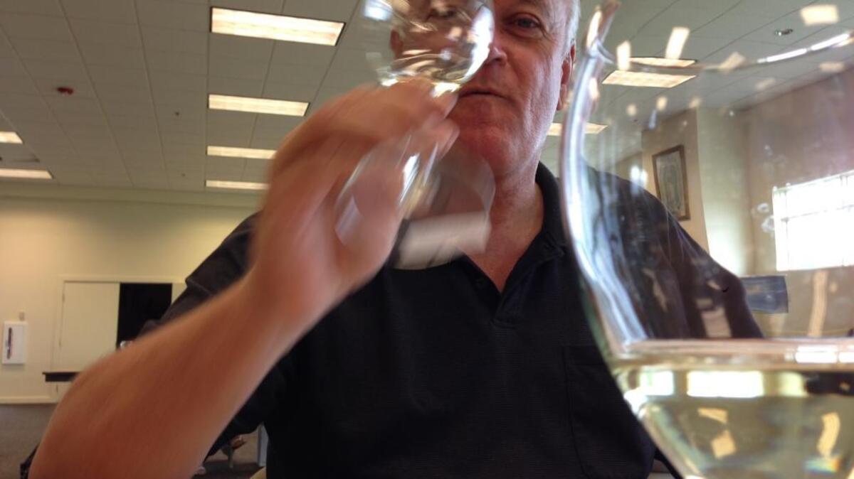 
Don Elsing, wine director for Sun Mountain Lodge in Winthrop, evaluates wine during the annual North Central Washington Wine Awards in Wenatchee.
