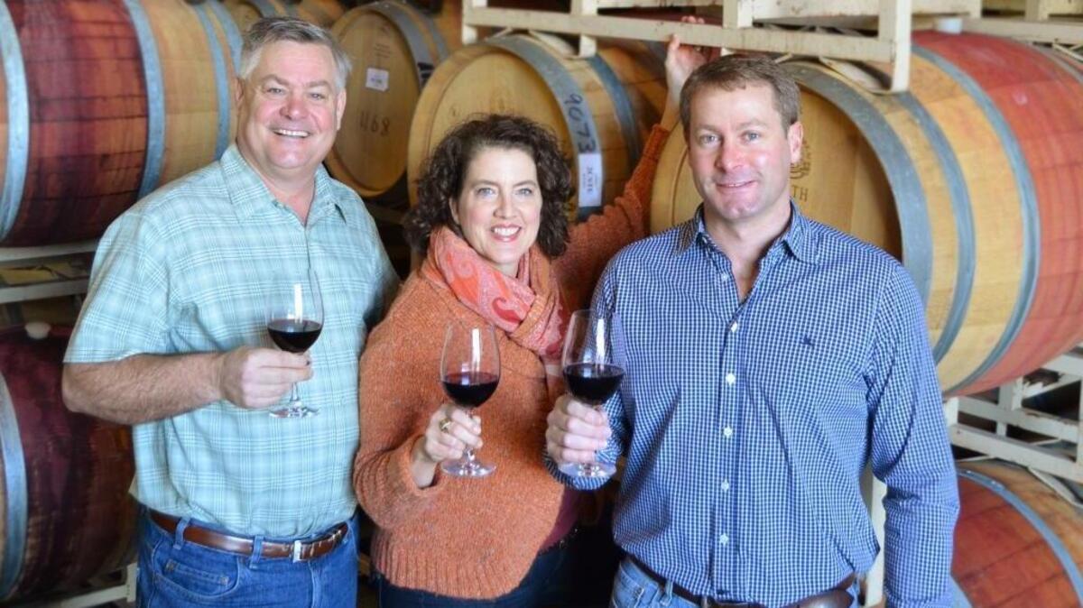 Maryhill owners Craig and Vicki Leuthold stand in their barrel room with head winemaker Richard Batchelor.