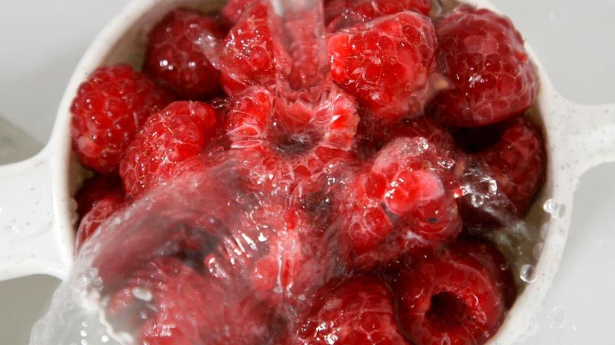 Raspberries are washed under water. Don’t soak any kind of berry in full sink of water because it may spread contamination.