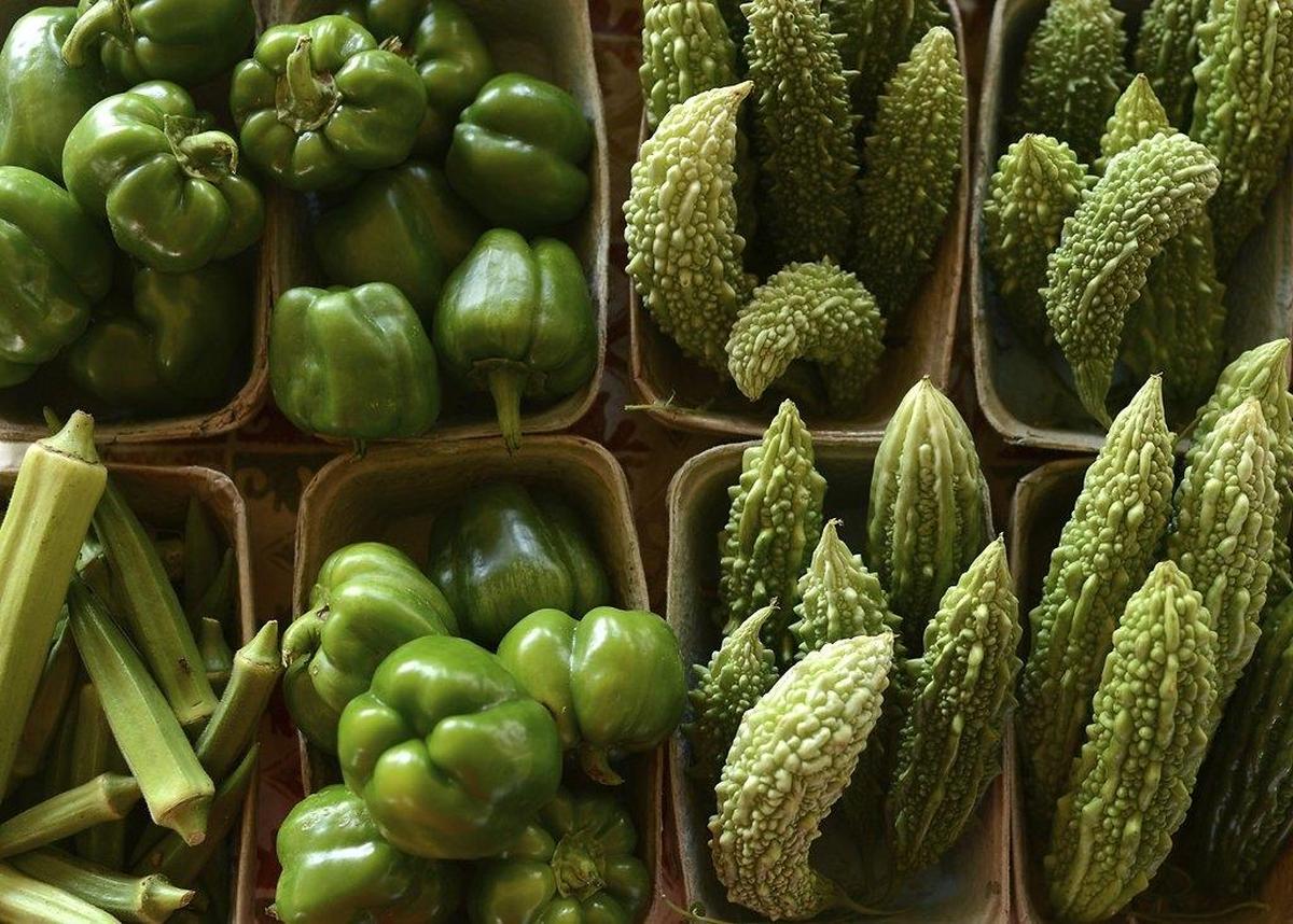 Bitter melon, green peppers and okra at a farmers market.