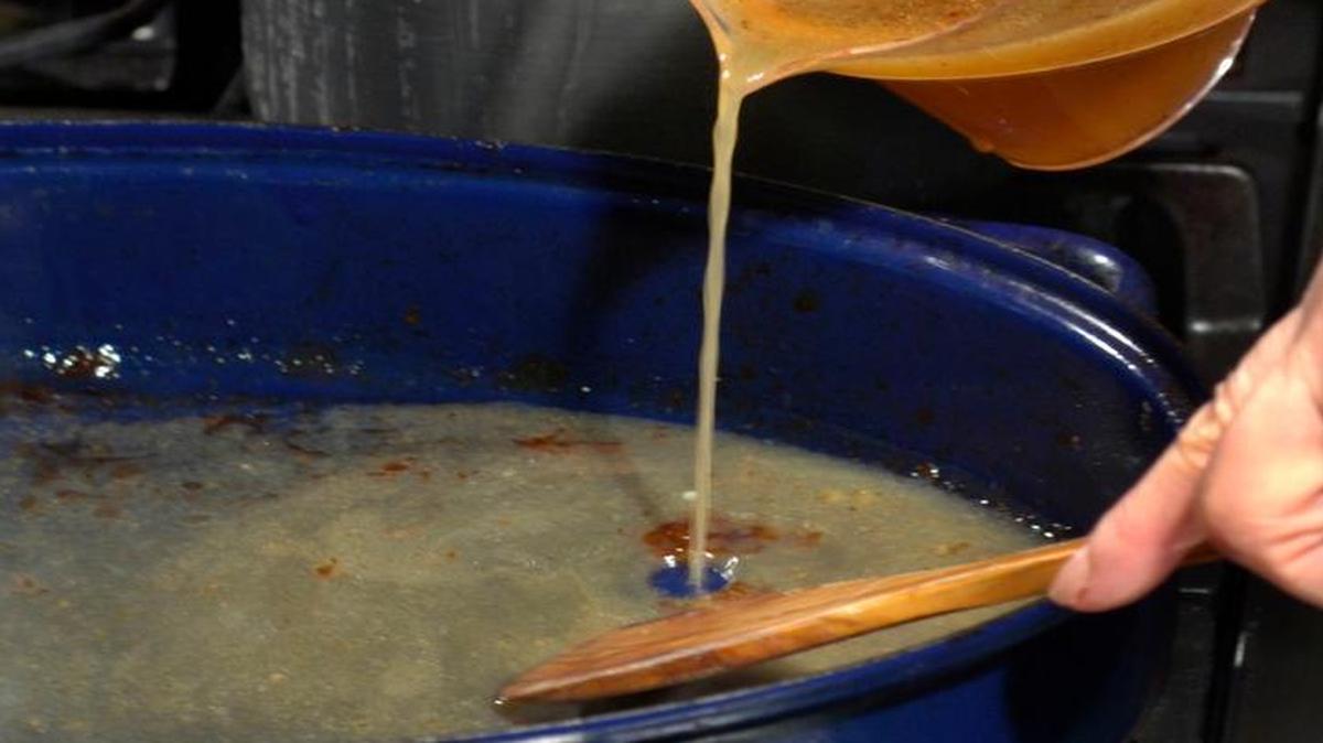 Keep your spoon moving when adding broth to your turkey gravy.