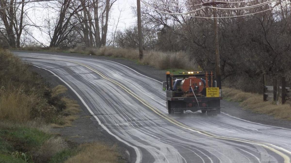 A city crew drives up South Cascade Street several years ago in Kennewick, spreading a liquid deicer on the pavement. De-icing salt has other chemicals that has been well documented to affect trees close to highways.