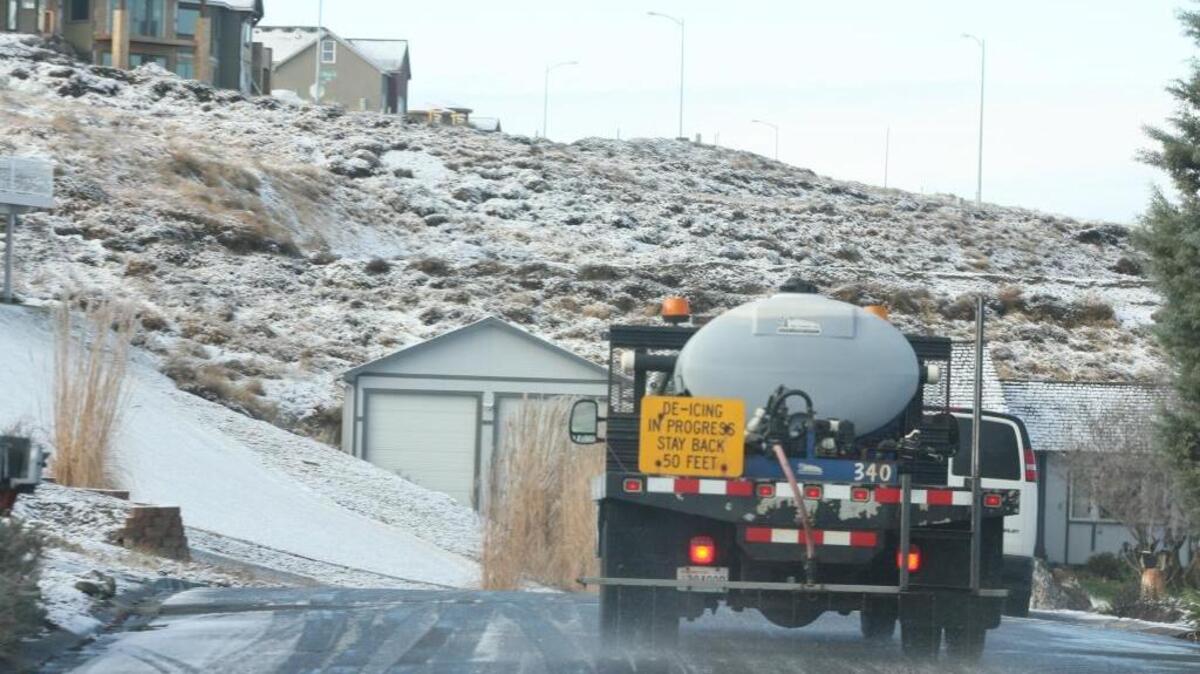 City workers apply de-icing solution to a steep hillside above Canyon Lakes on South Ledbetter Street in Kennewick several years ago. We may see salt burn on landscape plants close to roads and walkways where de-icing salts were used this winter.