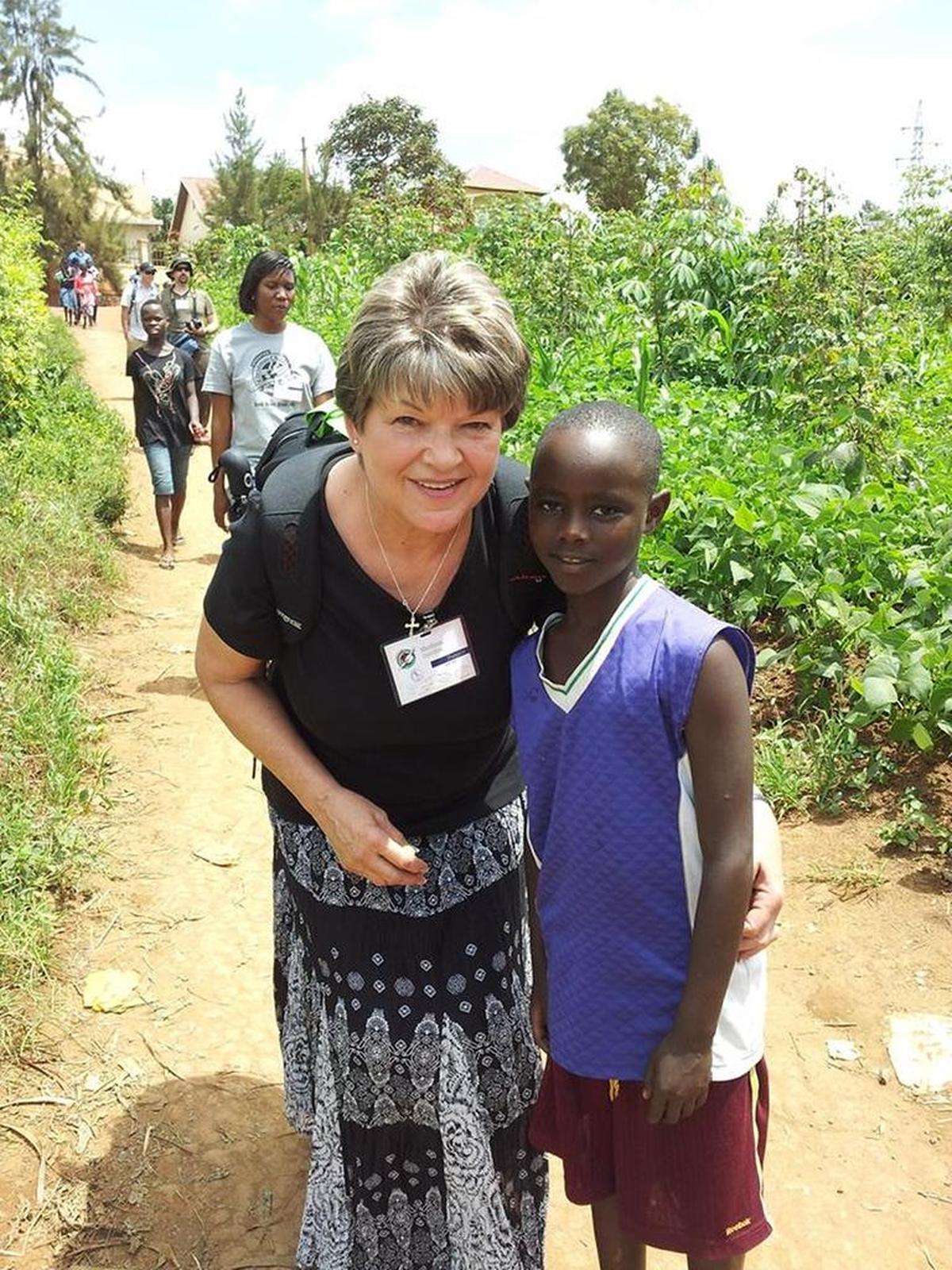 Marilynn Sanders pauses on a trail in Rwanda on her way to one of the distribution sites for the Operation Christmas Child shoeboxes.