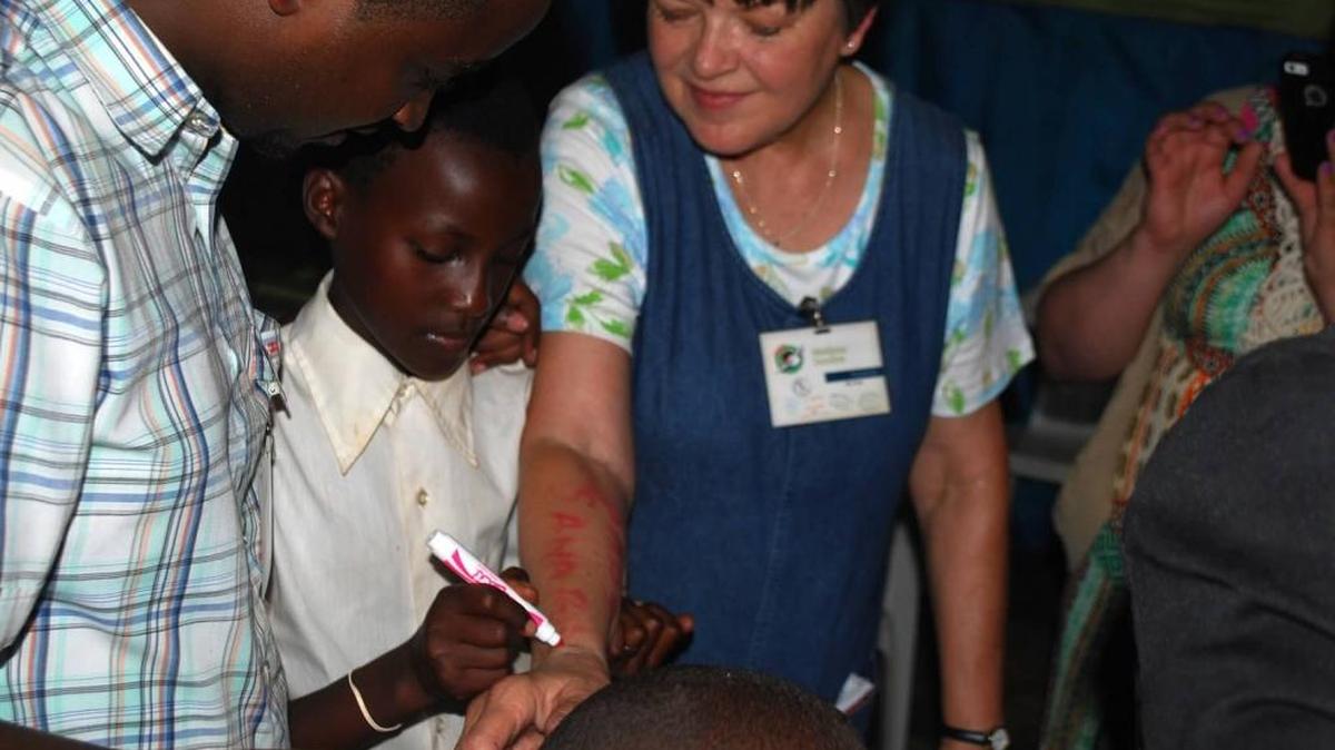 Marilynn Sanders traveled to Rwanda to deliver Operation Christmas Child shoeboxes as part of the Samaritan’s Purse ministry. The trip inspired her to write a poem of her memories, including this child writing on her arm.
