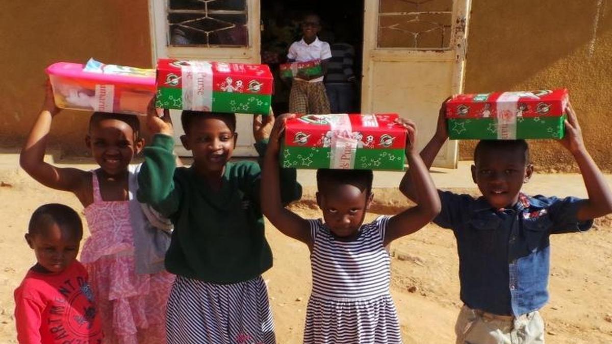 Delighted children personally received gift-filled shoeboxes when an Operation Christmas Child team visited Rwanda this summer.