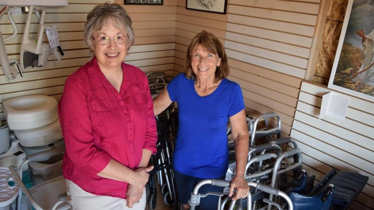 Dianna Salsbury and Karen Plate stand inside the Med Shed where used walkers, wheelchairs, and other items are stored at the Snohomish Evangelical Free Church.