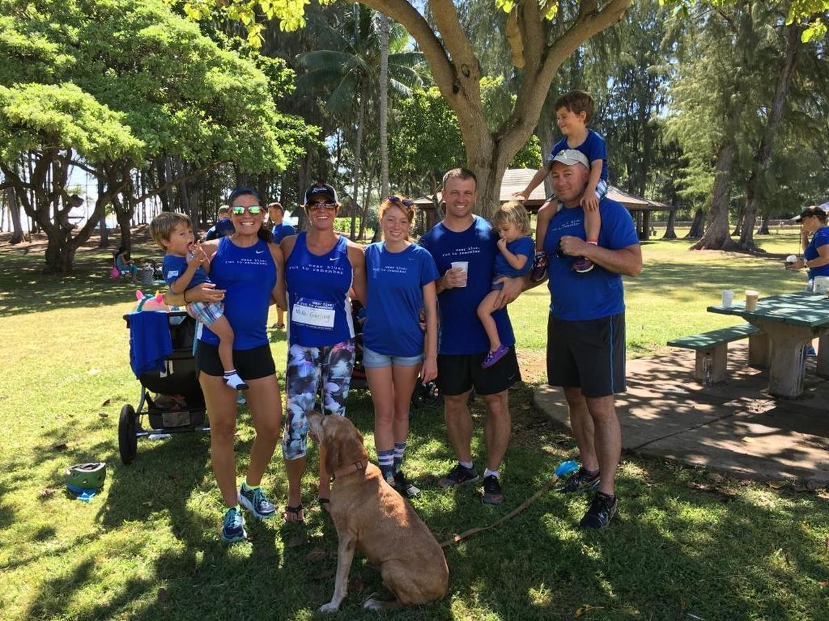“We chose to run on Memorial Day to help give our kids an idea of those that are fighting every day for our freedoms, and some who have lost their lives for it,” said US Army wife Traci LaRosa. “During the run it was hot, we were tired and thirsty, but those inconveniences are just small compared to what our troops face every day.” After the “wear blue: run to remember” run, Traci stands (second from left) with her family and the US Army Thiel family. Elizabeth Thiel is friends with Lisa Hallett, founder of the non-profit “wear blue: run to remember”. (Kailua Beach Park on Oahu, Hawaii)