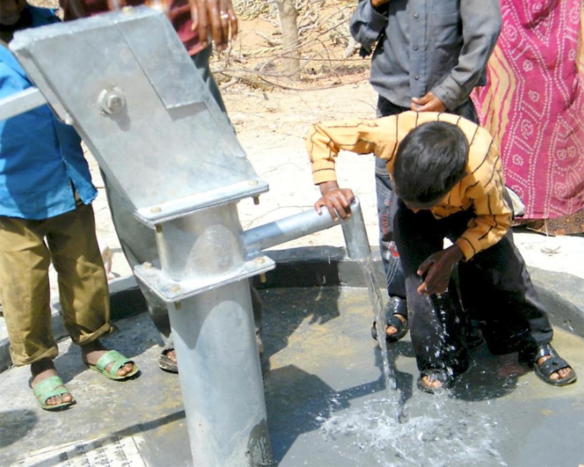 A young boy in northwest India enjoys a new well and water system developed by volunteers of Global Gateway Network founded by Micah Smith.