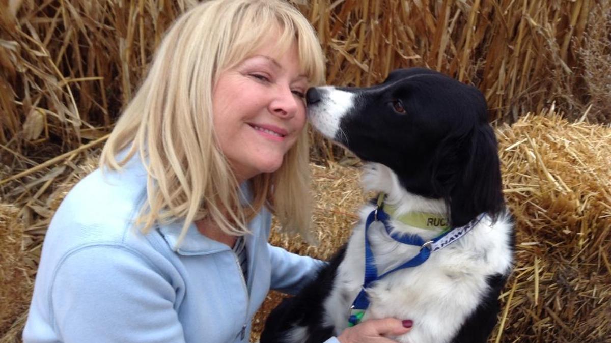 Kim Jasper of Moses Lake shares a special moment with Ruckus, the border collie she rescued.