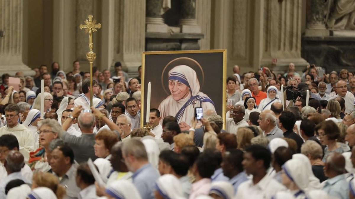 A portrait of Mother Teresa is carried in the crowd during a vigil of prayer in preparation for the canonization of Mother Teresa in the St. John in Latheran Basilica at the Vatican.