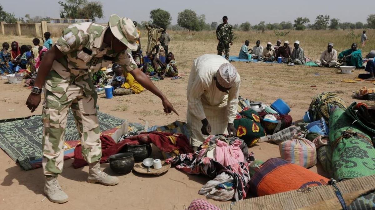 Soldiers guard people fleeing from Boko Haram’s carnage and about to be searched to ensure there are no insurgents infiltrating a refugee camp. People detained by the military and a civilian self-defense force are disappearing in northeast Nigeria, some wrongly accused of fighting for Boko Haram by neighbors settling old scores. The army says it is setting up a human rights office to investigate complaints. Amnesty International holds Nigeria’s military responsible for the deaths of some 8,000 detainees since 2011 — more than a third of the 20,000 people who have died in Nigeria’s Islamic uprising.