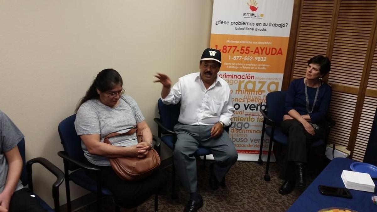Serafin Sanchez Cortes, center, discusses how his family was underpaid working as blueberry pickers in Walla Walla. His family received checks for back wages and damages Monday as the U.S. Department of Justice begins distributing proceeds from a lawsuit against Blue Mountain Farms and other growers to more than 1,000 workers. His wife, Emma Sanchez Cortes, is to the left. Michele Besso, an attorney with the Northwest Justice Project, is on the right.