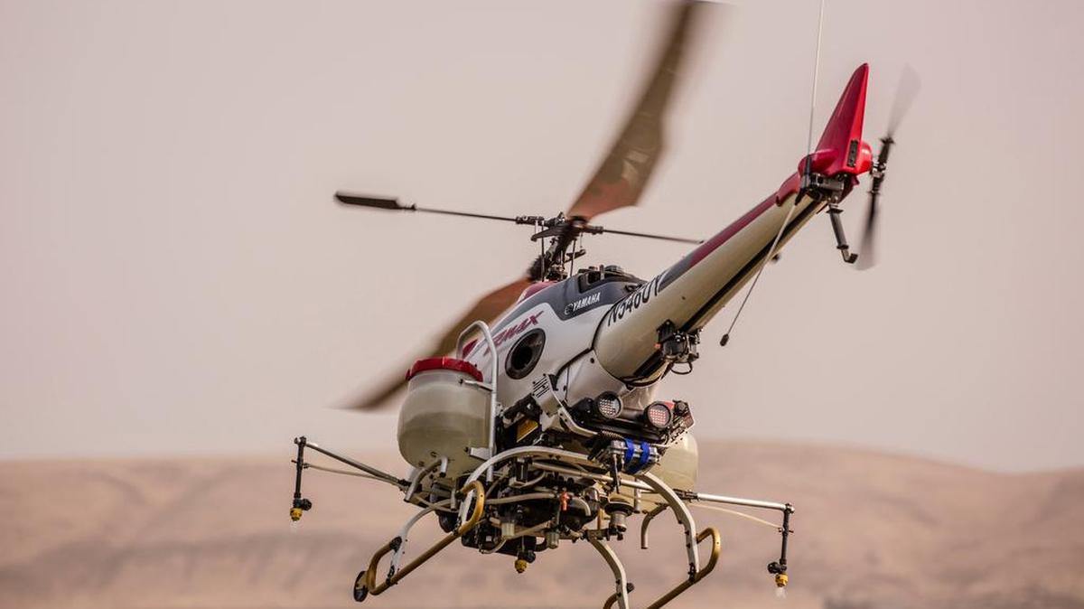 The Yamaha RMAX unmanned aerial crop spray helicopter drone flies over Terra Blanca Vineyard in Benton City. The flight last August was part of a series of demonstrations organized by Yamaha for tree fruit and vineyard operations.