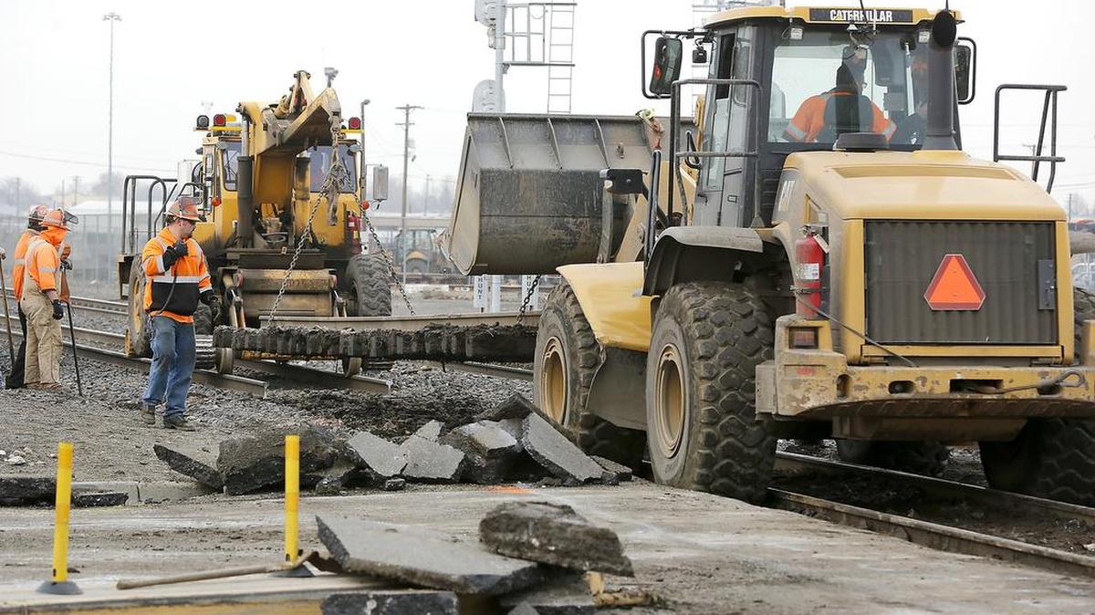 Workers from BNSF Railways work early Wednesday to fix a railroad crossing at First Avenue and “A” Street in Pasco. The ground under the crossing is saturated and muddy so workers were adding a gravel base before replacing the section of rails.