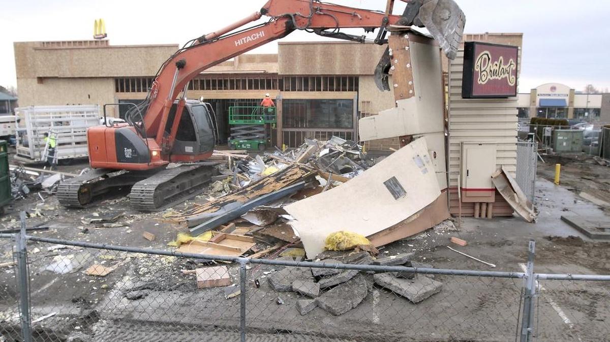 Eric Bower of C and E Trenching in Pasco manipulates the controls of his excavator Thursday to remove the exterior walls of the former Brûlant Espresso Bar building on the northeast corner of Steptoe Street and Gage Boulevard in Kennewick. The demolition of the estimated 1,500-square-foot building is part of a construction project of a new larger Circle K convenience store building directly behind it.