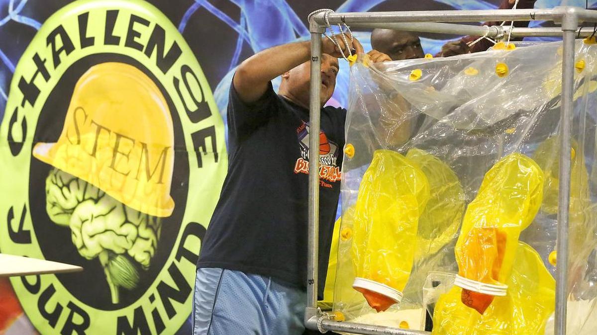 Jesse Perez, left, and Ron Childs, both Washington River Protection Solutions employees, work together Monday to set up their company’s booth for this year’s annual Health & Safety Expo at the TRAC facility in Pasco. The free two-day event runs from 7 a.m. to 7 p.m. May 10 -11. More than 150 booths will be featured.