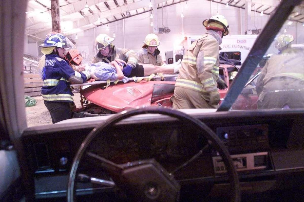 Hanford Fire Department firefighters and paramedics remove a mock accident victim from a car during a Vehicle Crash Demonstration at a previous Health and Safety Expo at TRAC. This year’s event is canceled.