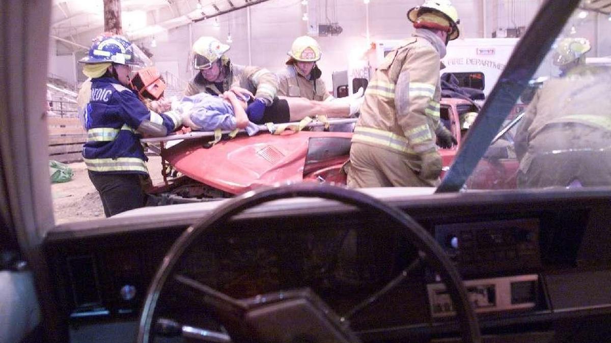 Hanford Fire Department firefighters and paramedics remove a mock accident victim from a car during a Vehicle Crash Demonstration at a previous Health and Safety Expo at TRAC. This year’s event is canceled.