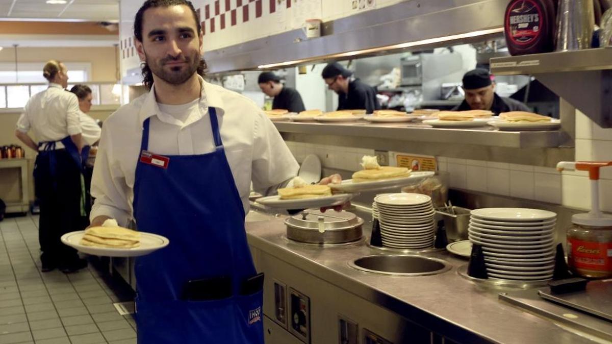 IHOP server Mel Campos of Richland carries plates of free pancakes to customers Tuesday afternoon at the Kennewick restaurant during the annual National Pancake Day fundraiser to benefit Children’s Miracle Network Hospitals.