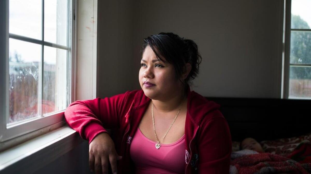 While working in a hop field this spring, Adriana Flores and 46 other workers were affected by wafting pesticides sprayed on a nearby alfalfa field. Her 18-month-old son, Adrian Mora, sleeps at right at their home in Wapato.