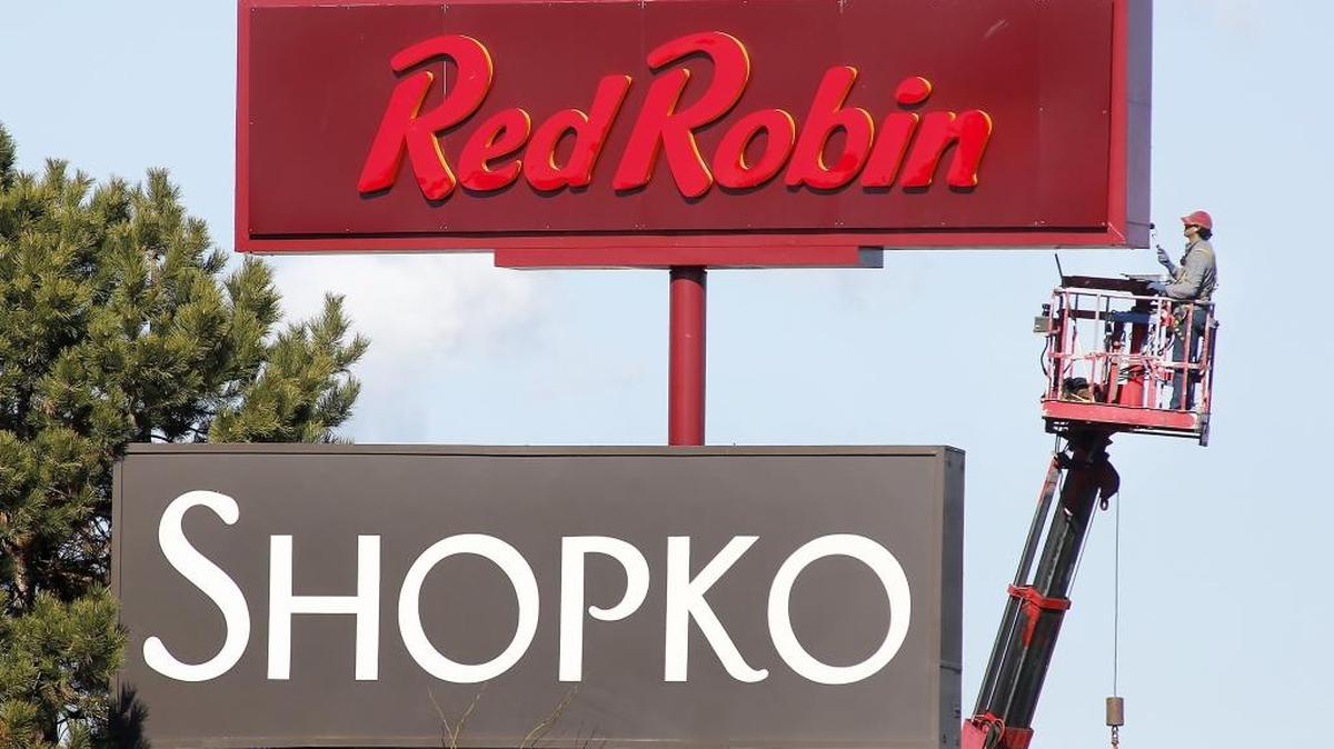 Mark Stephenson, an employee of Quality Signs, works under Monday’s sunny skies about for the Red Robin restaurant at 1021 Columbia Center Blvd. in Kennewick. Stephenson was working from a bucket truck about 35 feet in the air to roll on a coat of new paint. More sunny weather and a high temperature in the low-50s is forecast today for the Tri-City area.
