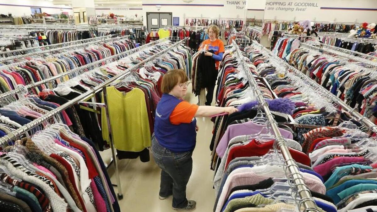 Client Jamie Arnold, left, and lead cashier Debbie Simonen join a group of workers Tuesday morning preparing the sales floor of the newest Goodwill Industries of the Columbia thrift store in east Kennewick. The store, formerly the Shop CI Thrift Store, is holding an 11 a.m. ribbon cutting ceremony Jan. 13. The event at 810 S. Dayton St. is open to the public and will offer tours of the organization’s fifth store in the Tri-Cities. The store’s grand opening is at 7 a.m. Jan. 14, said store manager David Arellano.