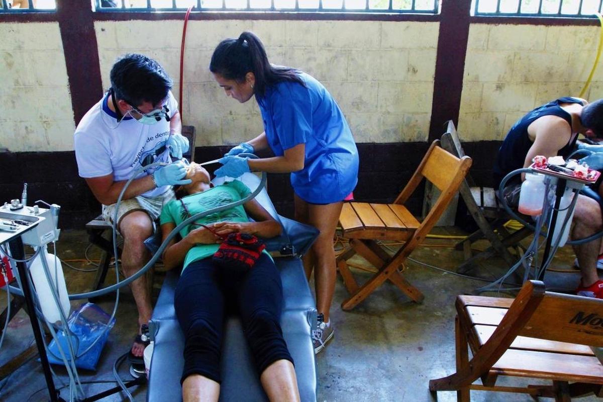 Dr. Bart Roach of Three Rivers Dental in Kennewick, left, and Dr. Revenda Bebawi treat a patient in El Paredon, Guatemala, in November 2016.