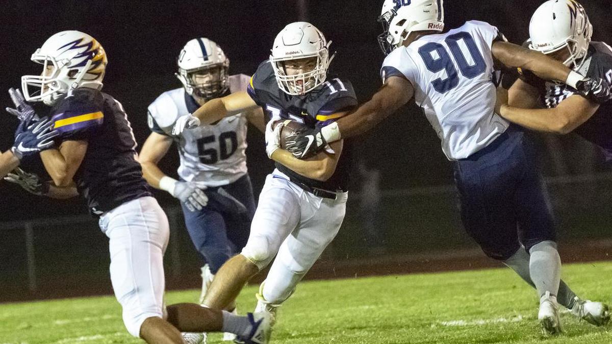 Hanford Falcons running back Jared DeVine (11) breaks through Chiawanna Riverhawks defense during a Mid-Columbia Conference football game.