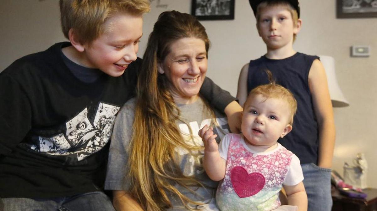 Recovering drug addict Carla Cook says she’s grateful to have been selected to participate in the Elijah Family Homes program with her sons Spencer, 11, left, and Ryder, 9, and granddaughter Delonnie Nave, 10 months. The family is living in a Richland home that has provided a sense of stability and independence, Cook said.