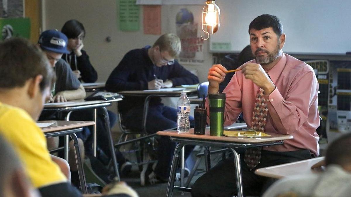 
Jerry Riggs, Richland High assistant principal, responds Tuesday to one of 10 citizenship questions in the “hot seat.” Social studies teacher Nicholas White challenged Richland School District staff to pass a student version of the American citizenship test. White added dramatic lighting and sound effects in each of his four classes. Watch a video at: www.tricityherald.com/video.
