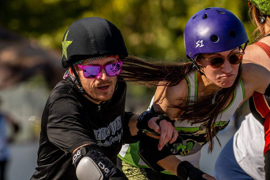 Atomic City Roller Derby skater Albert Whipple and Marisa Quirk battle during a scrimmage at Highland Grange’s outdoor skating rink in September 2025.