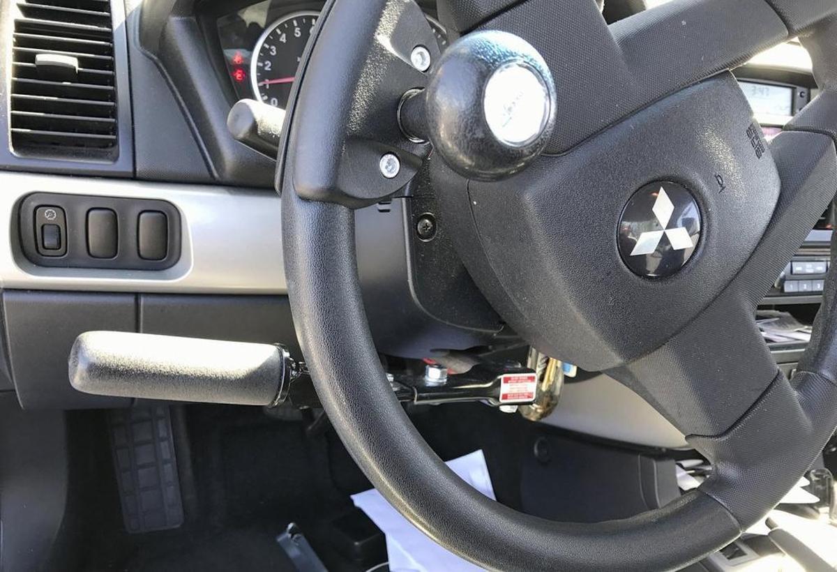 Hand controls outfitted to Hassan Yusuph's Mitsubishi Gallant allowed the 35-year-old paraplegic the independence to drive and go to work.