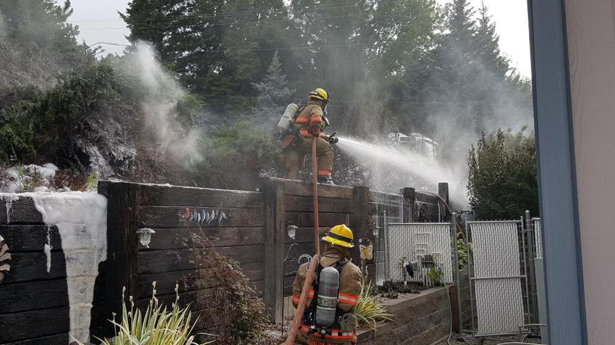 A fire that burned through juniper trees Monday threatened nearby buildings in Kennewick.