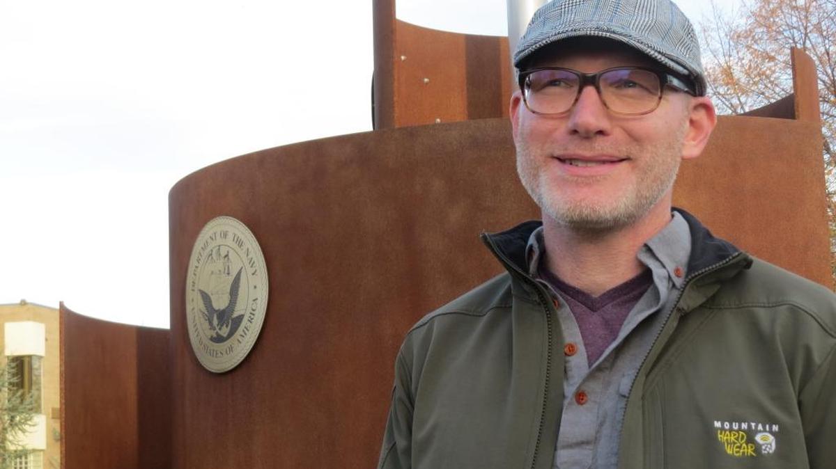 Jason Schlegel, Columbia Basin College’s director of veterans services, stands in front of the college’s veterans memorial.