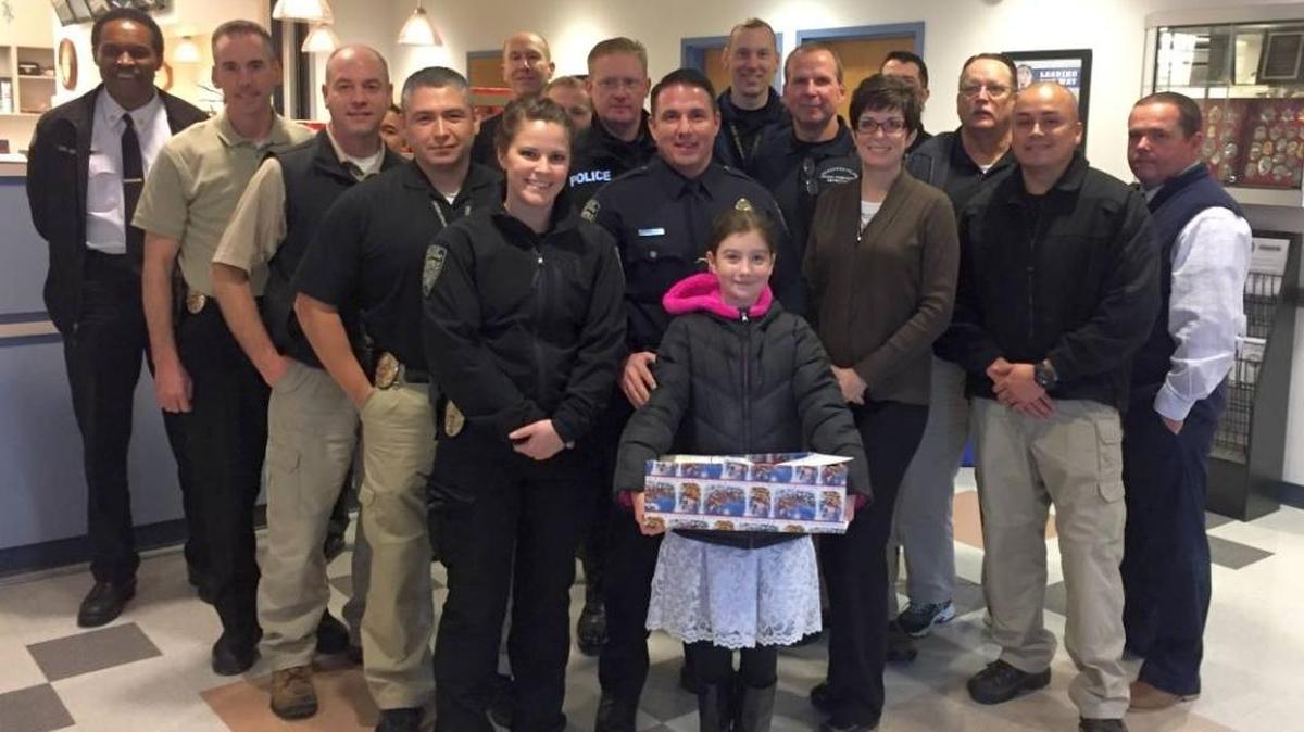 Sean Moberg, 10, brought instant cakes to the Kennewick police to show her thanks for the officers.