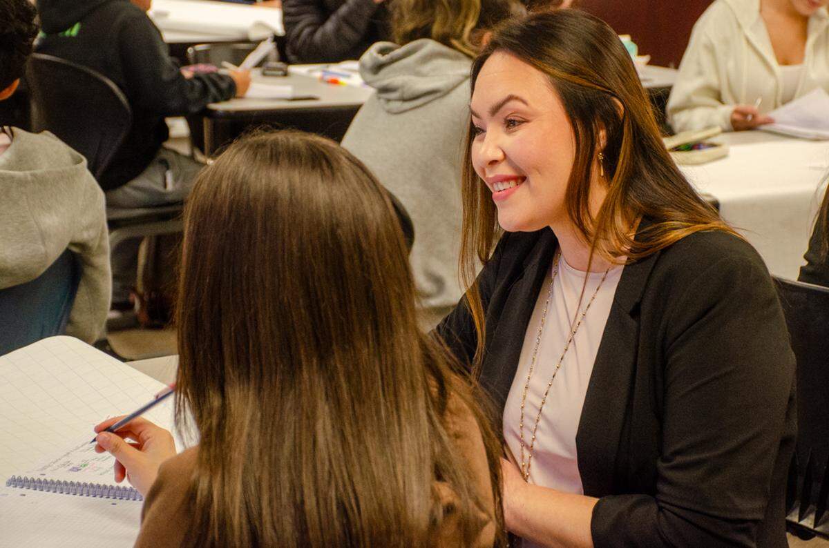 Pasco High School bilingual math teacher Gabriela Whitemarsh helps students in her class. As a former Bulldog, she saw opportunity gaps for English language learners in math and worked to correct that two decades later as a teacher.
