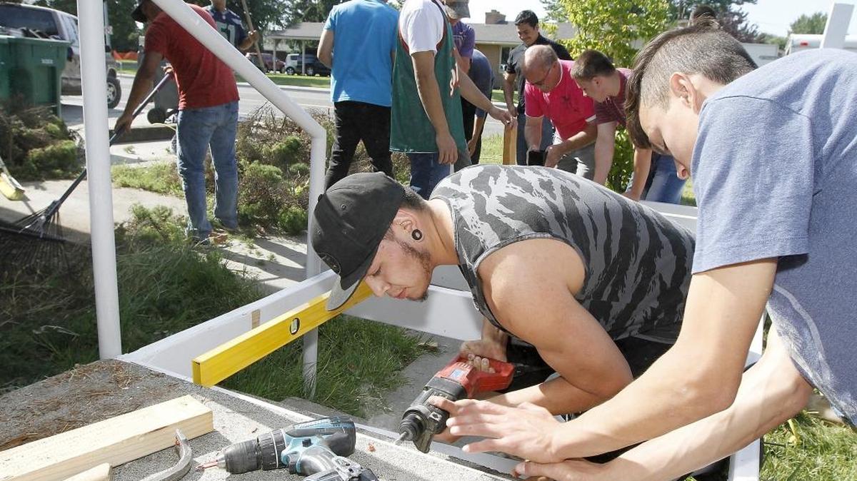 Southridge High senior Elijah Gomez, left, and Hanford High junior Logan Butler, both Tri-Tech Skills Center construction trades students, work together Tuesday to build a wheelchair ramp for a homebound senior citizen in Kennewick. About 40 students from the program were scheduled to help with the ramp building, repairs and cleanup of the house on West 27th Avenue, according instructor Tony Milewski. The program is a community service partnership with the Columbia Valley Daybreak Rotary Club in Kennewick. The club buys the constructions materials for the students to install, according to club member Brandon Miln. Watch a video at tricityherald.com/video