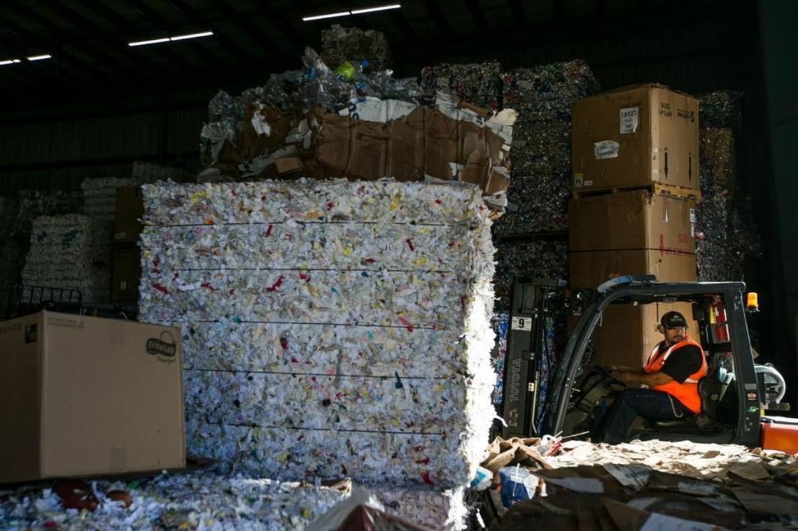 An employee at Central Washington Recycling moves bales of recycling Friday to an area for delivery to buyers in Yakima.