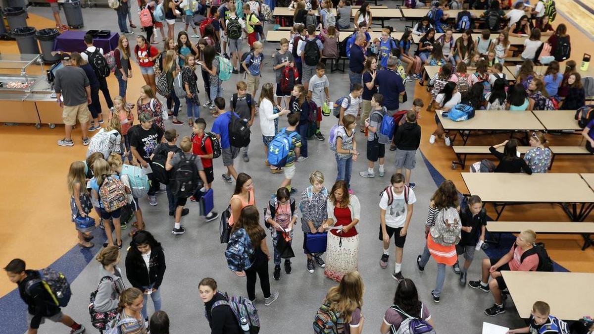 Students gather in the cafeteria before school starts Tuesday during the first day of school at Desert Hills Middle School in Kennewick. See a video at www.tricityherald.com/video.