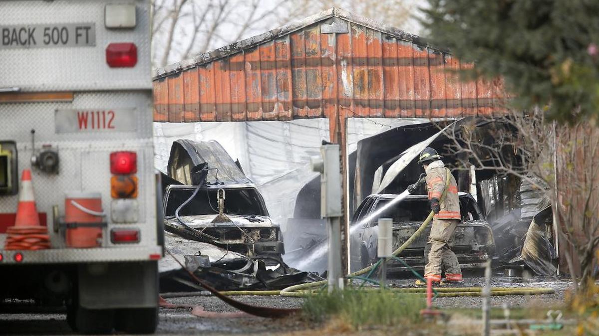 A Benton County firefighter sprays smoldering spots Tuesday morning at 33606 2138 PR S.E. in Finley. The cause of the early morning fire, just east of the intersection of Haney and Cochran Roads, is under investigation.