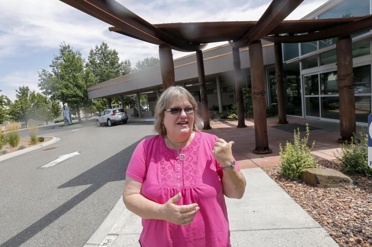 Bonnie Causey stands outside the Tri-Cities Cancer Center in Kennewick and keeps her car running with the air conditioner so the patient won’t have to ride in a hot car after their doctor’s appointment.