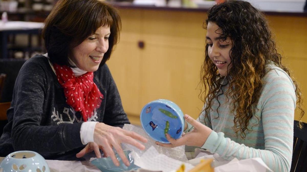 Ignite Youth Mentoring of Richland has laid off its paid staff, leaving its volunteers supported by a volunteer board. This photo from 2016 shows Stephanie Valencia, 12, right, and her Ignite mentor Carol Serle looking over pottery they had painted together.